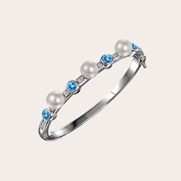 cylinder hinge bangle with alternating three white pearls and blue sapphires