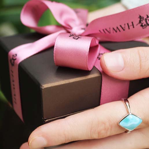 jewelry box by Island by Koa Nani held by a model wearing a classic Larimar ring