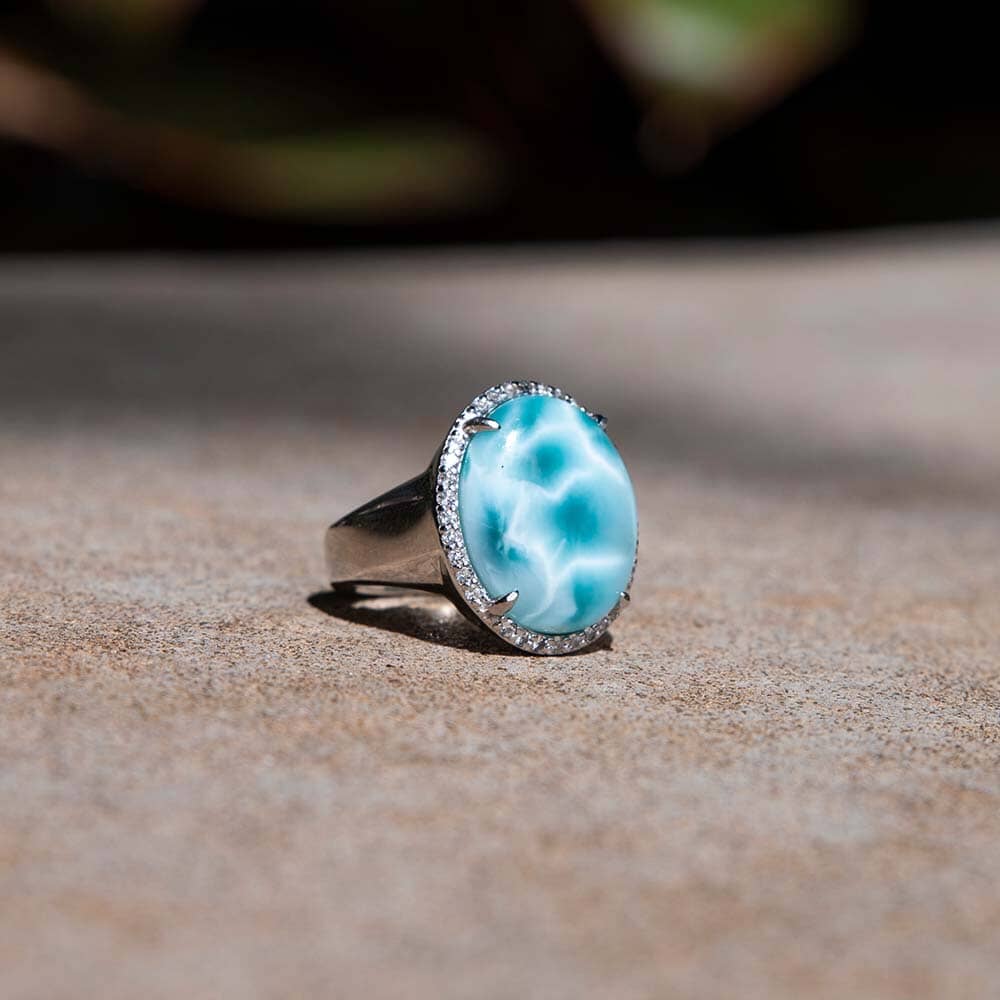 Larimar Gemstone care featuring an ocean blue larimar gemstone ring with topaz around the ring