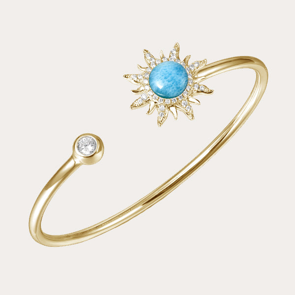 celestial collection featuring gold sleek bangle sun design with diamond and ocean blue larimar