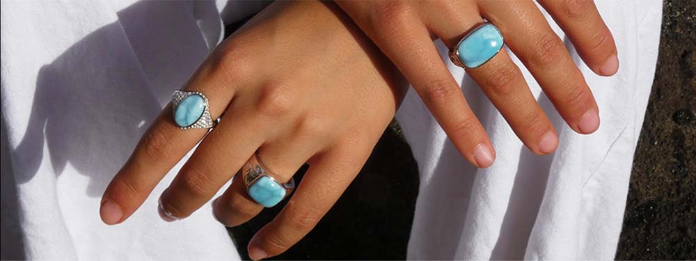 care and repair banner features different classic Larimar rings on both a model's hand