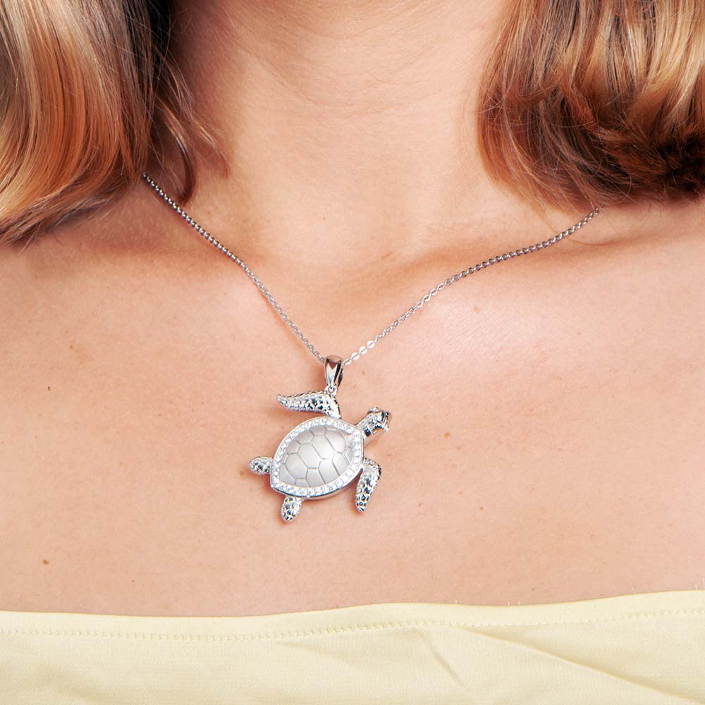 rhodium plated on a silver sea turtle pendant worn around a neck