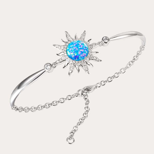 celestial bracelet collection featuring a sustainable blue opal sun bracelet lined with white topaz