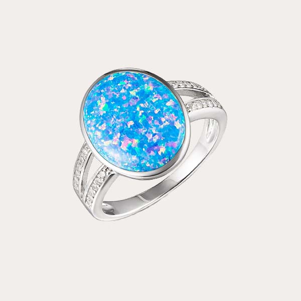 celestial opal collection featuring a sustainable blue opal split band ring lined with white topaz