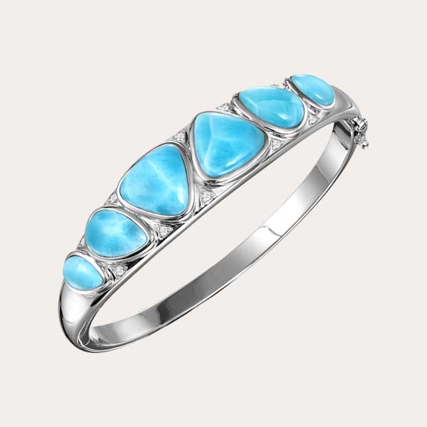 classic bracelet collection feature six ocean blue Larimar gemstone lined on a hinged cylinder bangle with two white topaz gemstones between each Larimar