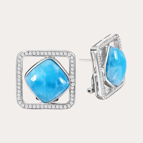 classic earrings collection features square stud earrings lined white topaz gems around the edges and a diamond shape ocean blue Larimar gemstone in the middle