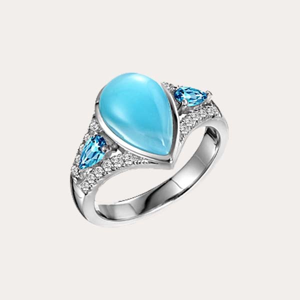 classic Larimar gemstone features a teardrop shaped ocean blue Larimar cocktail ring lined with diamonds and blue aquamarine 