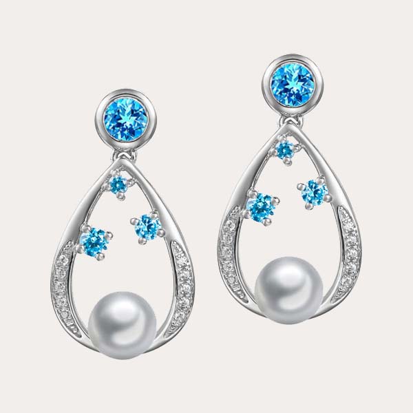 classic pearl collection feature dangling earrings and stud backing in teardrop motif with white pearl and white and blue topaz gemstones