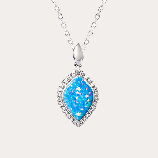 classic pendant collection features a mandorla shaped sustainable opal with white topaz along the edges