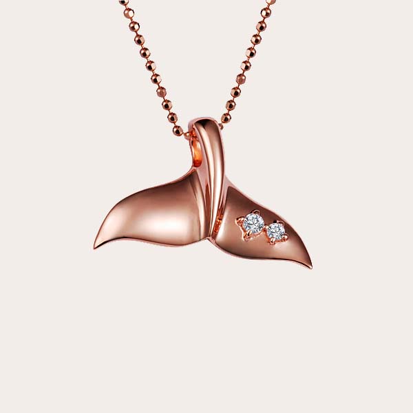 rose gold whale tail pendant with two diamonds on the right fluke