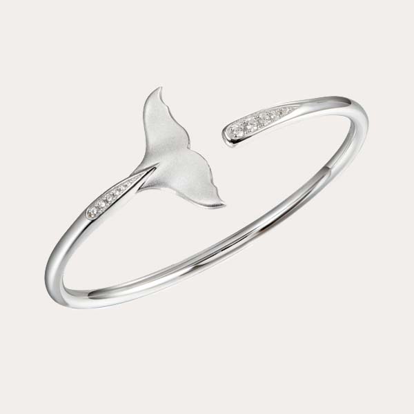 sea life bracelet collections features a silver flexi bangle with whale tail motif and white topaz on each end