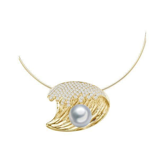 In this photo there is a yellow gold wave pendant with diamonds and one white pearl.