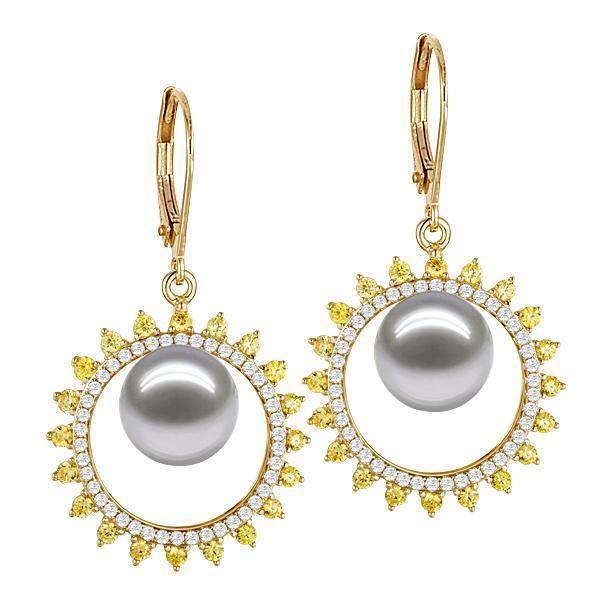 In this photo there is a pair of yellow gold sun earrings, with yellow and white diamonds and white/light gray Akoya pearls.