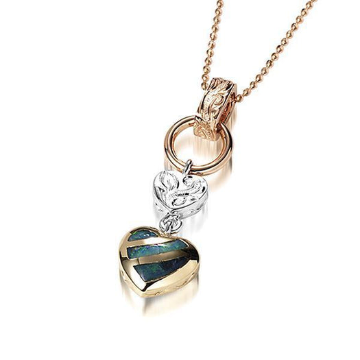 This picture shows a 14K yellow and white gold charm pendant featuring a heart motif paired with opal.