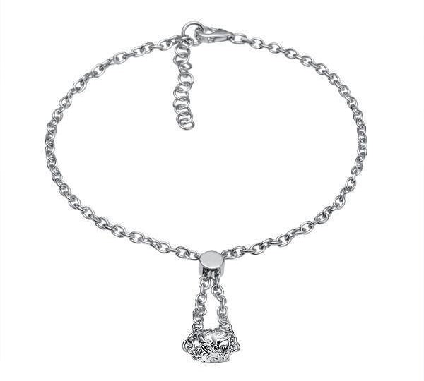 The picture shows a 14K white gold barrel bracelet with scroll engraving.