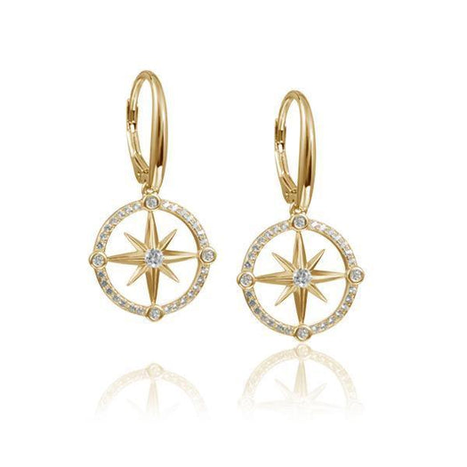 In this photo there is a pair of 14k yellow gold compass lever-back earrings with diamonds and aquamarine gemstones.
