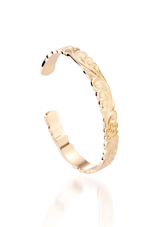 The picture shows a 14K yellow gold hand-engraved bangle sea turtle design with cut-out edges.