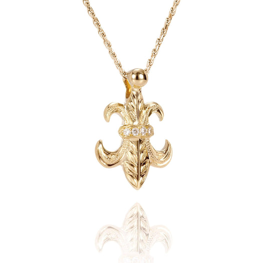 The picture shows a large 14K yellow gold fleur de lis pendant with hand engravings.