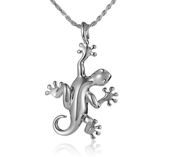 In this photo there is a white gold gecko pendant.