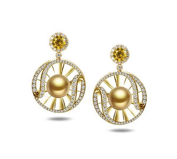 In this photo there is a pair of 14k yellow gold sun and wave dangle earrings with golden pearls, diamonds, and citrine.