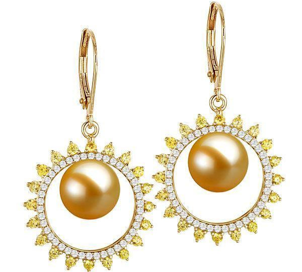 In this photo there is a pair of 14k yellow gold sun lever-back earrings, with yellow and white diamonds and golden south sea pearls.