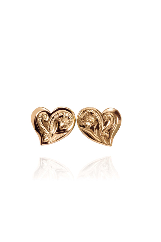 In this photo there is a pair of 14k yellow gold heart stud earrings with plumeria flower engraving.