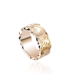 The picture shows a 14K yellow gold cut out 8 mm ring with hand engravings including sea turtles.