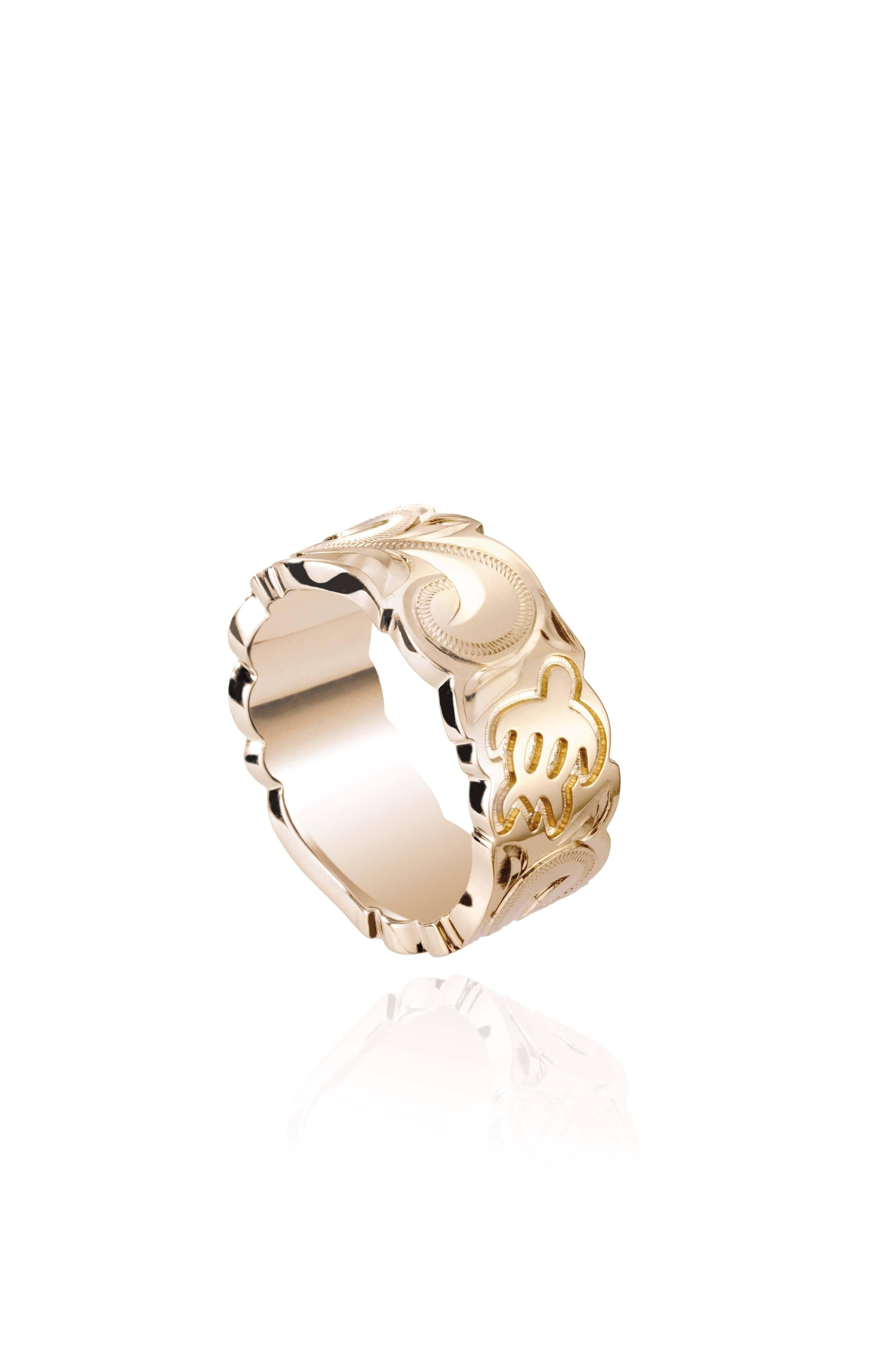 The picture shows a 14K yellow gold cut out 8 mm ring with hand engravings including sea turtles.