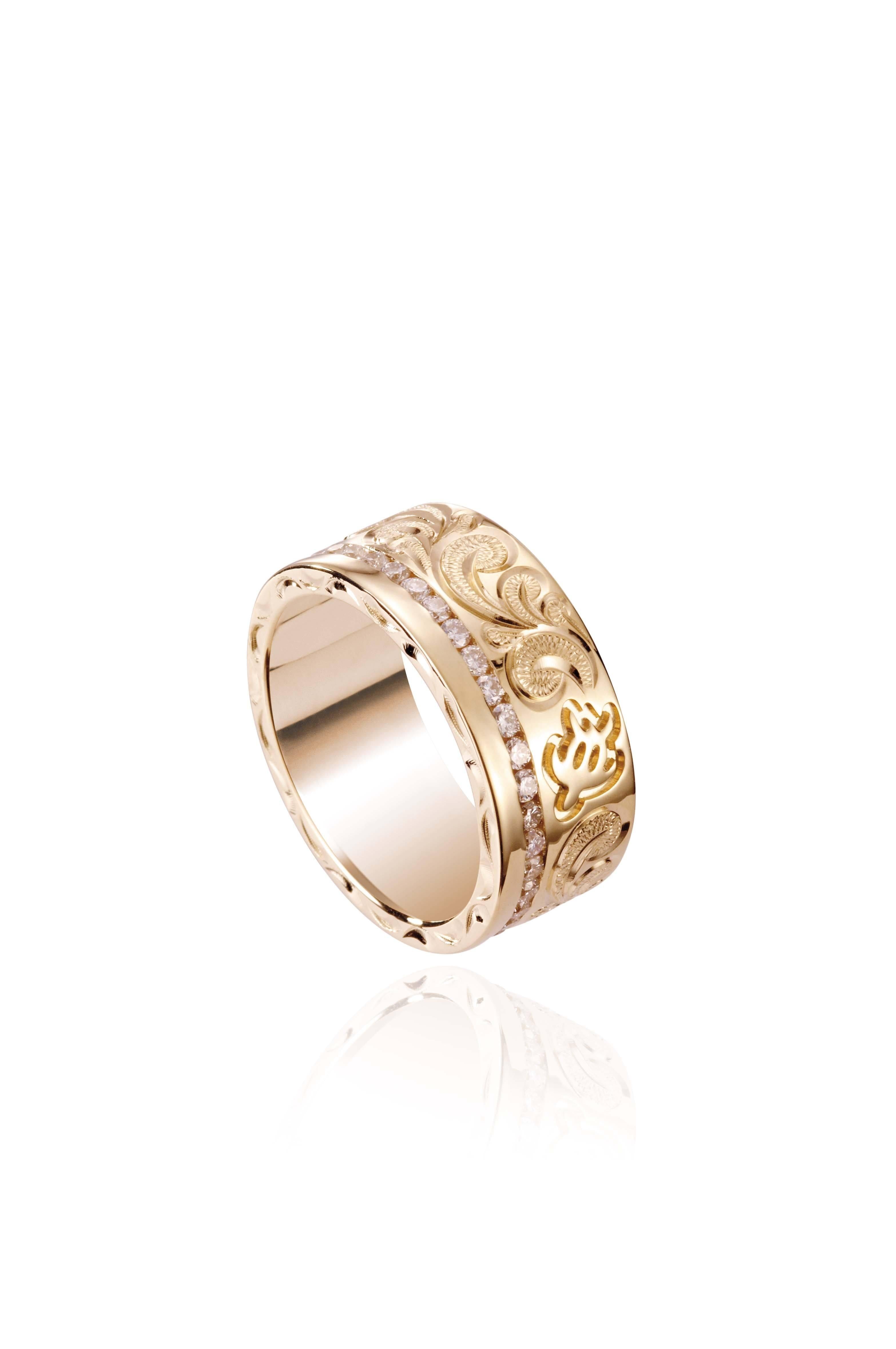 The picture shows a 14K yellow gold diamond Channel 8 mm ring with hand-engravings, including a sea turtle.
