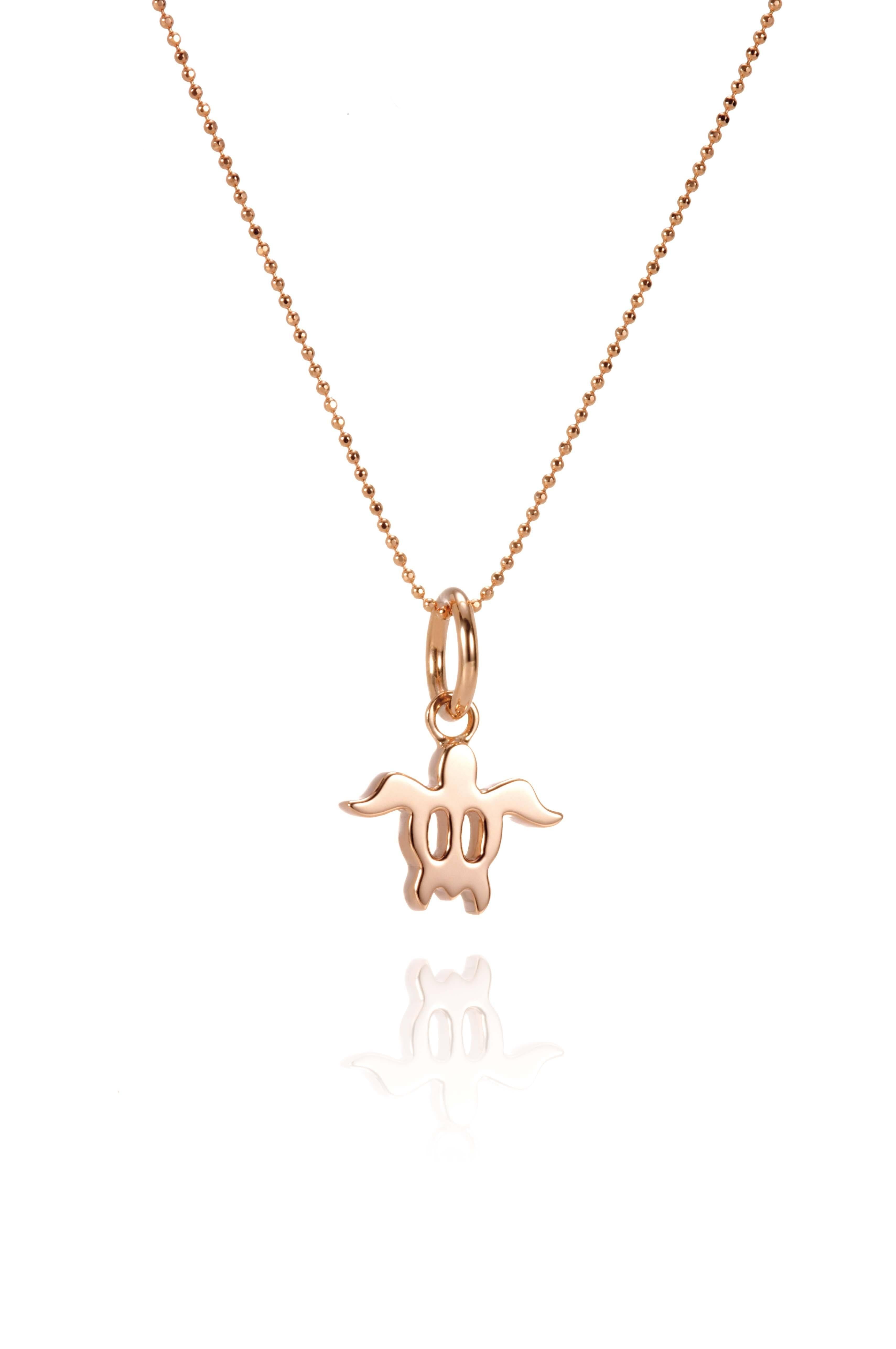 The picture shows a 14K rose gold sea turtle pendant.
