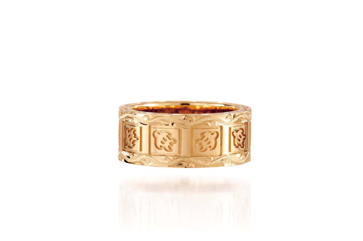 The picture shows a 14K yellow gold 8 mm ring with hand engravings including sea turtles.