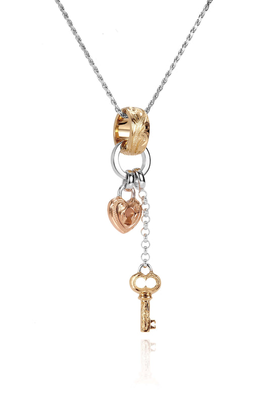 The picture shows a 14K yellow, rose, and white gold key and lock charm pendant with hand engravings.