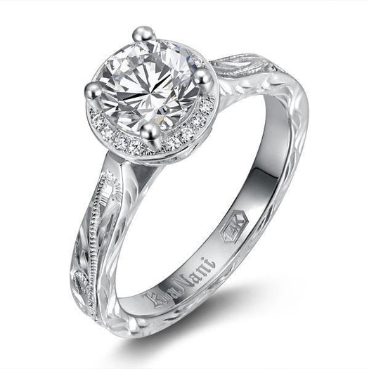 The picture shows a 14K white gold wave engagement ring with diamonds and traditionally inspired hand-engravings.