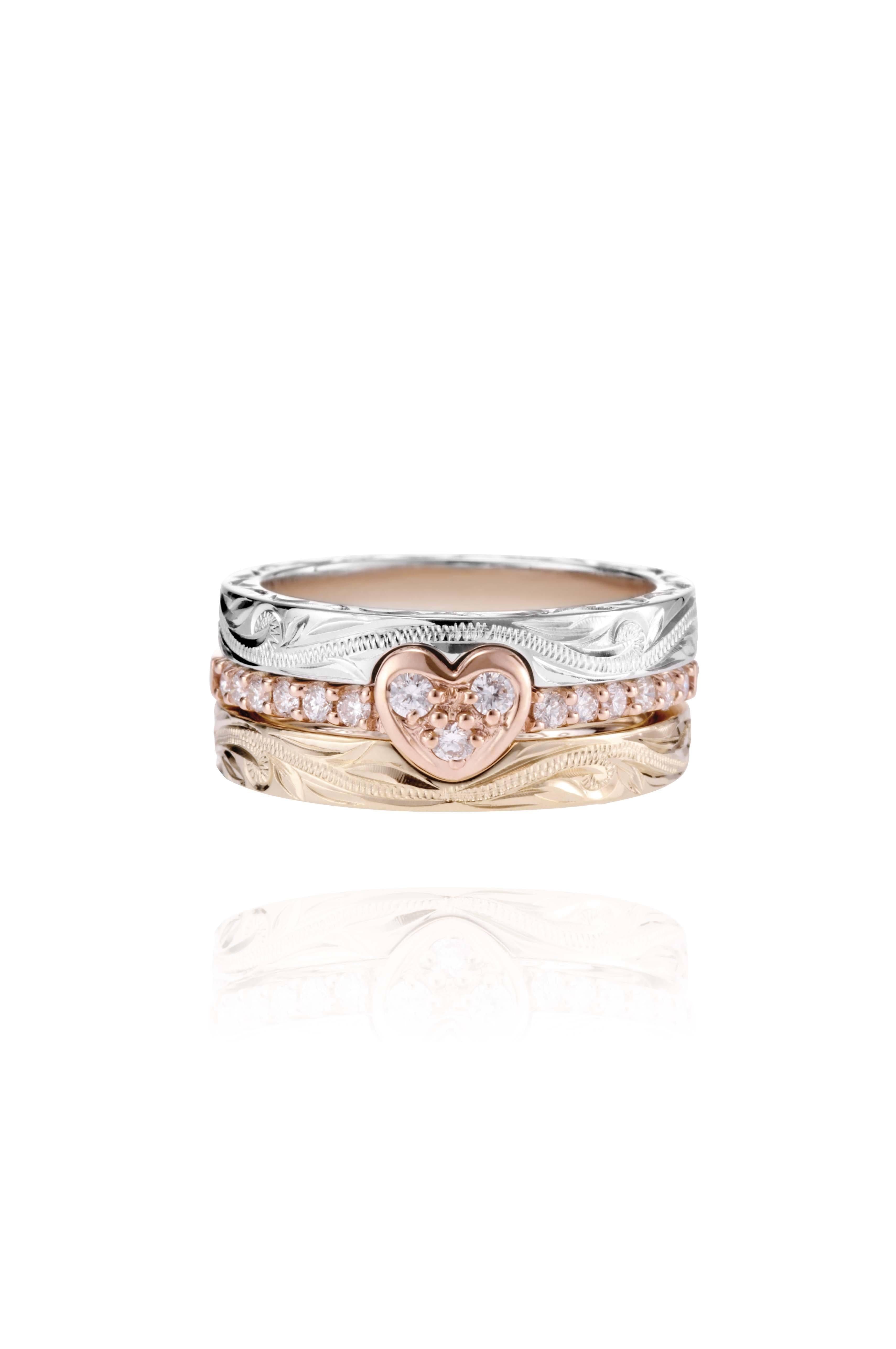 The picture shows a 14K white gold, yellow, and rose gold, tri-color rings. The rose gold heart ring features diamonds.