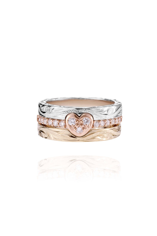 The picture shows a 14K white gold, yellow, and rose gold, tri-color rings. The rose gold heart ring features diamonds.