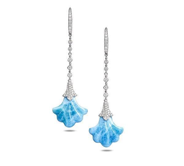 In this photo there is a pair of 14k white gold Hawaiian lily earrings with blue larimar gemstones and diamonds.