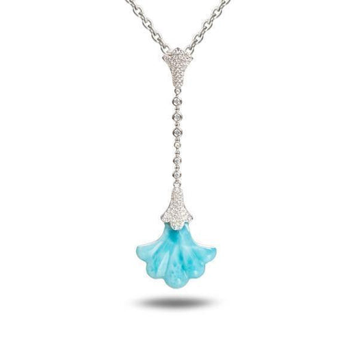 In this photo there is a white gold Hawaiian lily pendant with a blue larimar gemstone and diamonds.