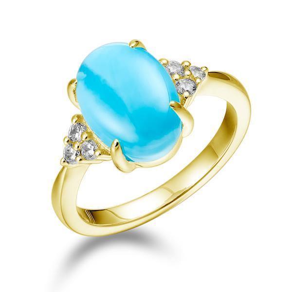 The picture shows a 14K yellow gold larimar oval ring with diamond trios.