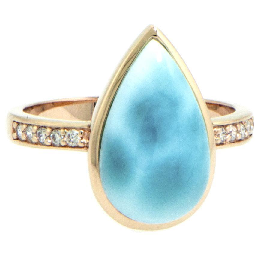 The picture shows a 14K yellow gold larimar teardrop ring with a diamond band.