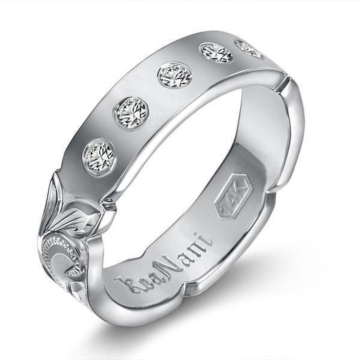 The picture shows a 14K white gold 4mm ring with hand engravings and diamonds.