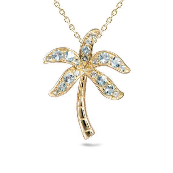 In this photo there is a yellow gold palm tree pendant with aquamarine gemstones.