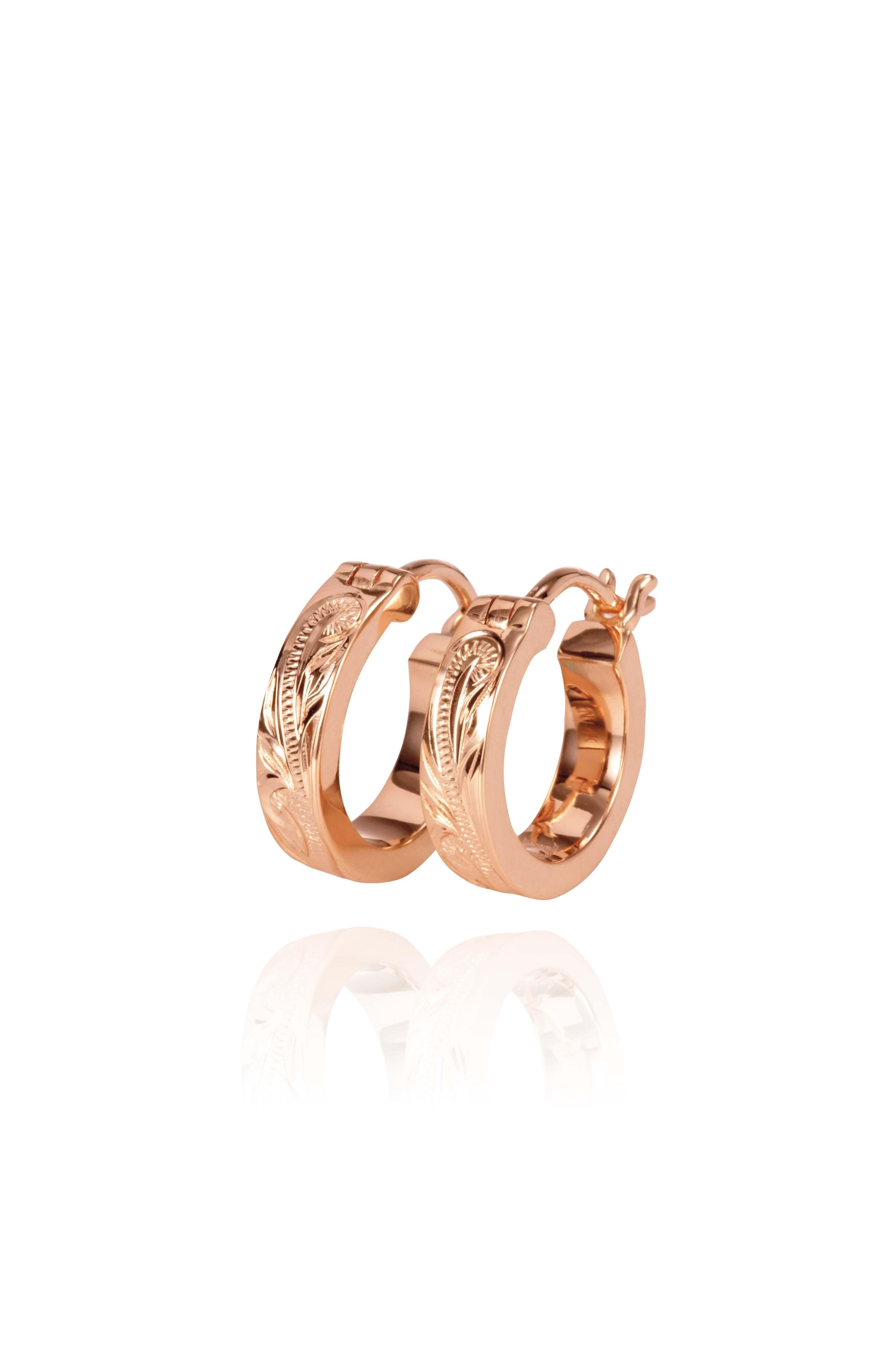 The picture shows a pair of 14K rose gold mini hoop earrings with scroll engraving.