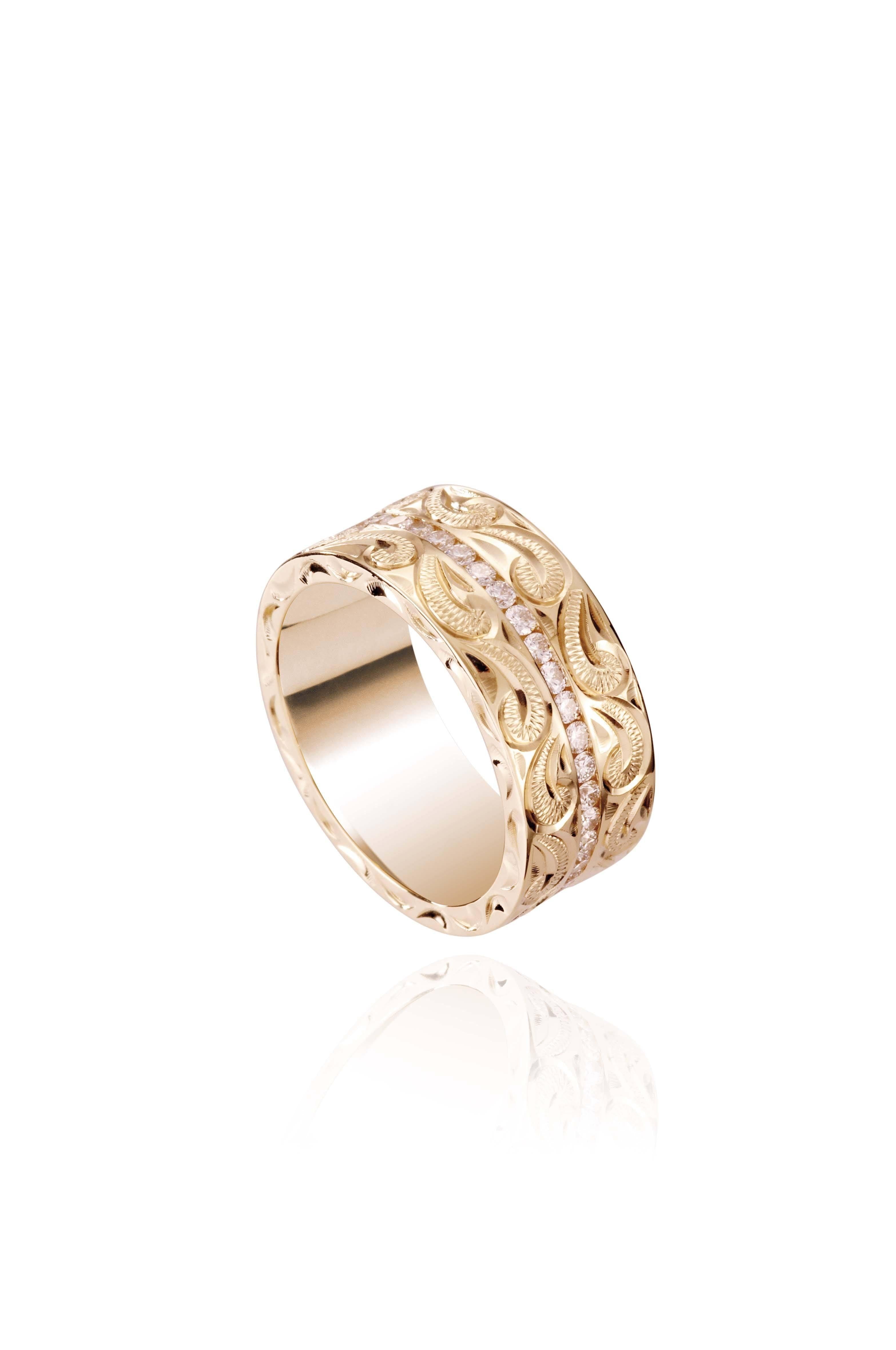 The picture shows a 14K yellow gold wave diamond channel 8mm ring with hand-engravings.