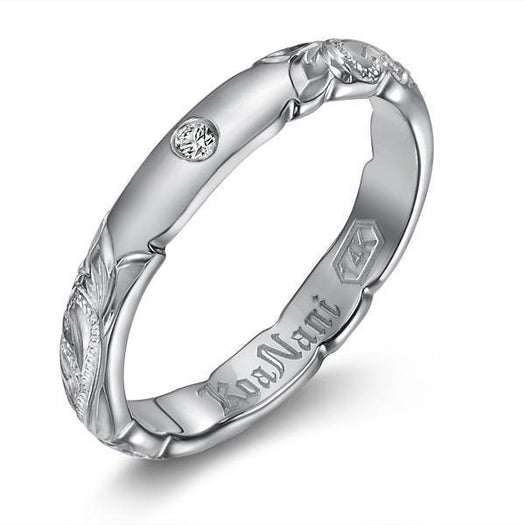 The picture shows a 14K white gold diamond 3mm ring with hand engravings and a diamond.