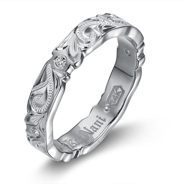 The picture shows a 14K white gold wave infinity ring with diamonds and hand engravings.