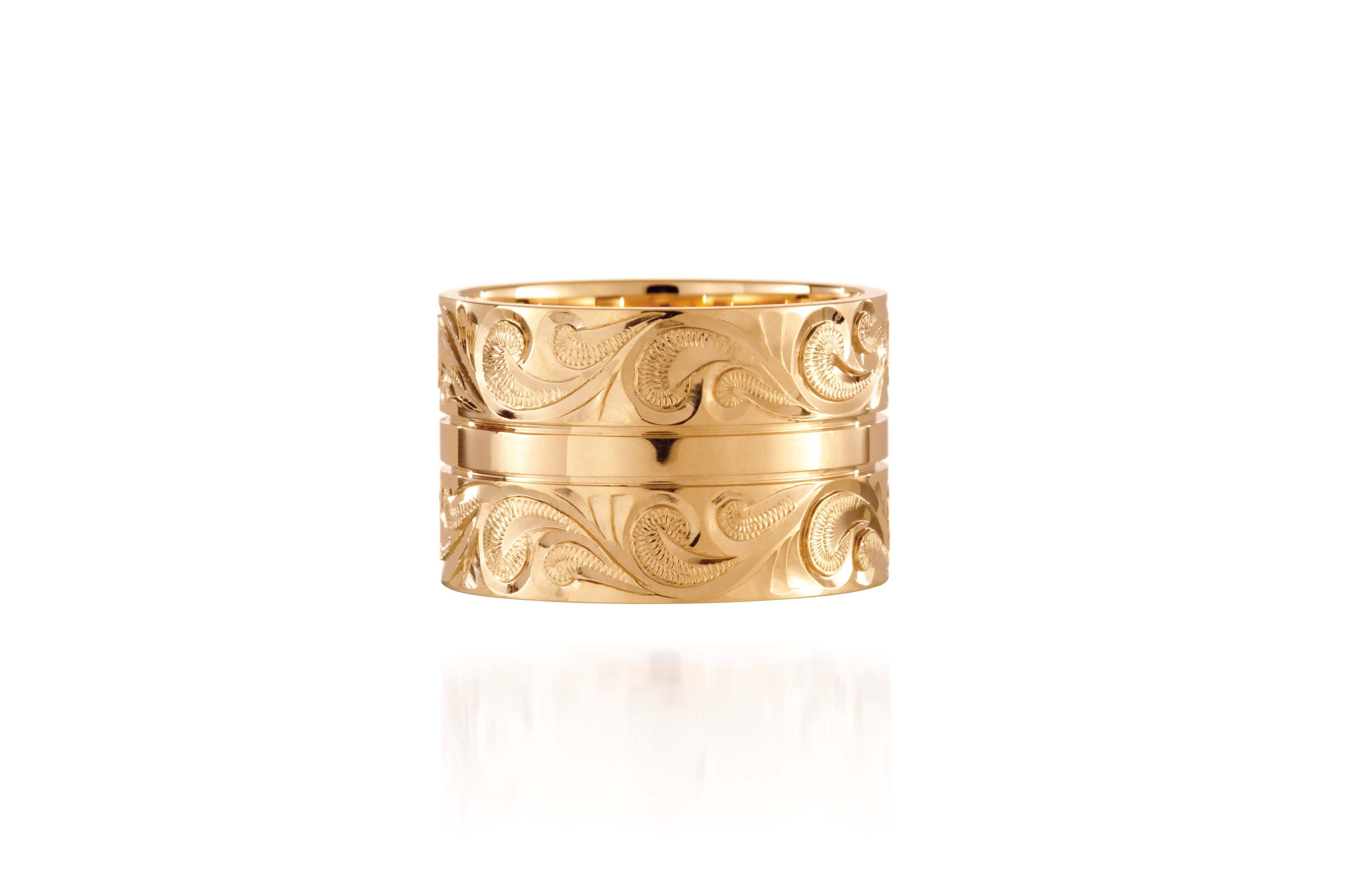 The picture shows a 14K yellow gold 12 mm ring with hand engravings.
