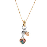 The picture shows a 14K yellow, white, and rose gold opal two-heart charm pendant with hand engravings and a diamond.