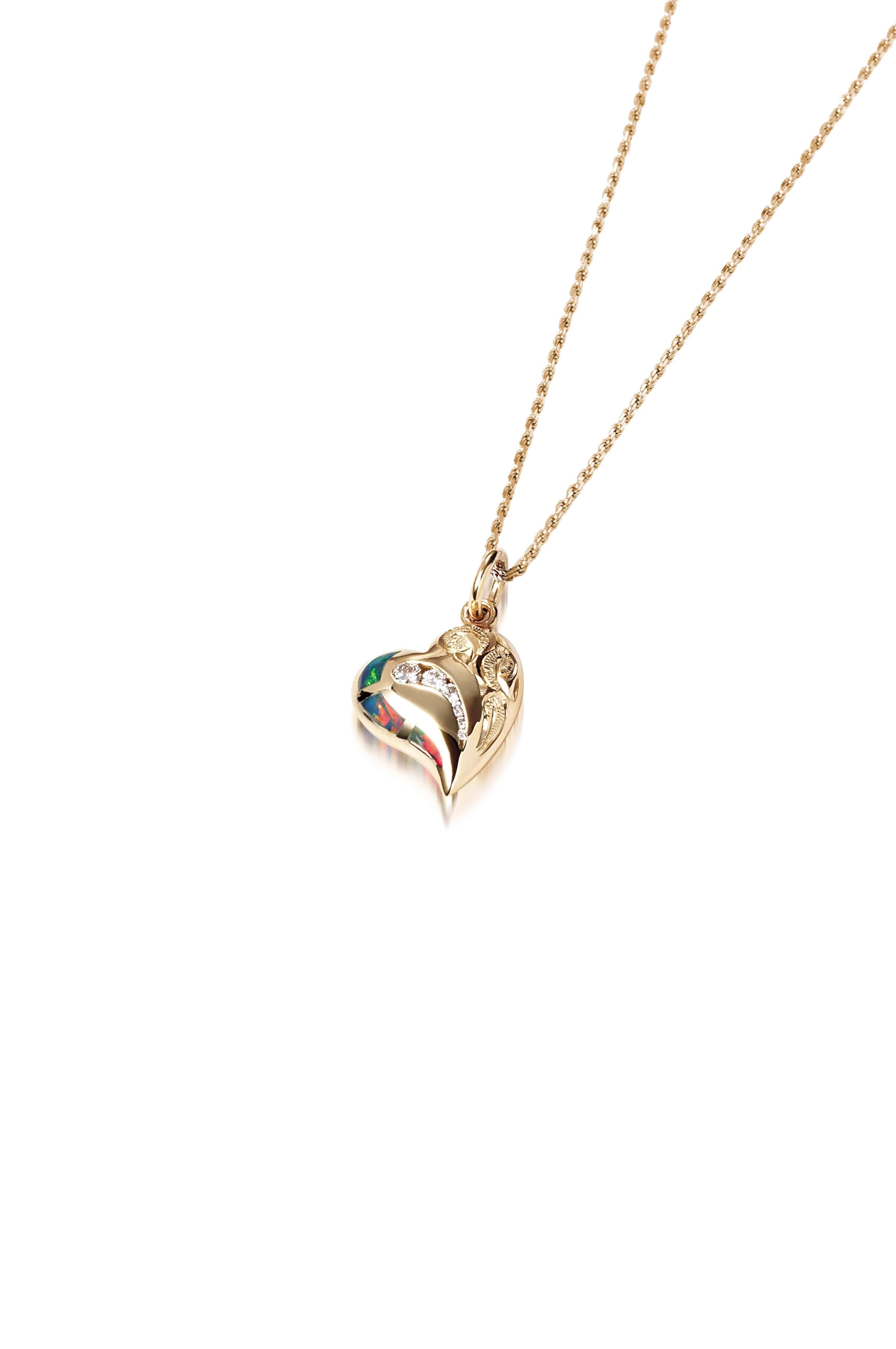 The picture shows a 14K yellow gold opal heart pendant with hand engravings.