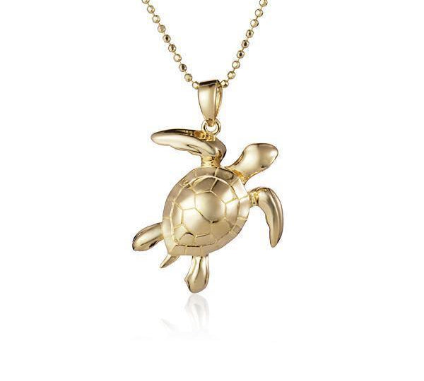 The picture shows a 14K yellow gold sea turtle pendant.