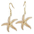 The picture shows a pair 14K yellow gold pavé diamond starfish hook earrings.